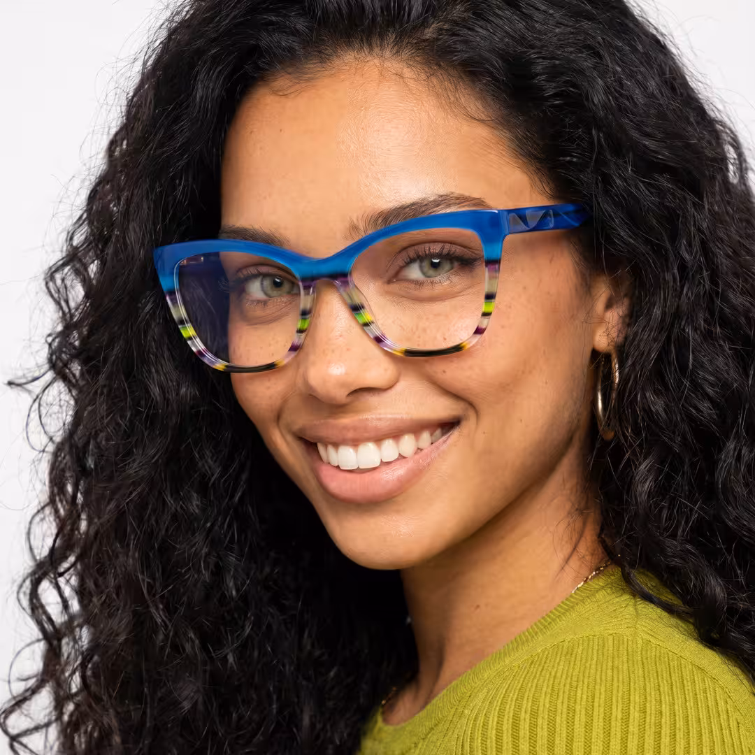 Female wearing colorful blue cat eye acetate eyeglasses, smiling while looking at camera. SPU: CA0452605