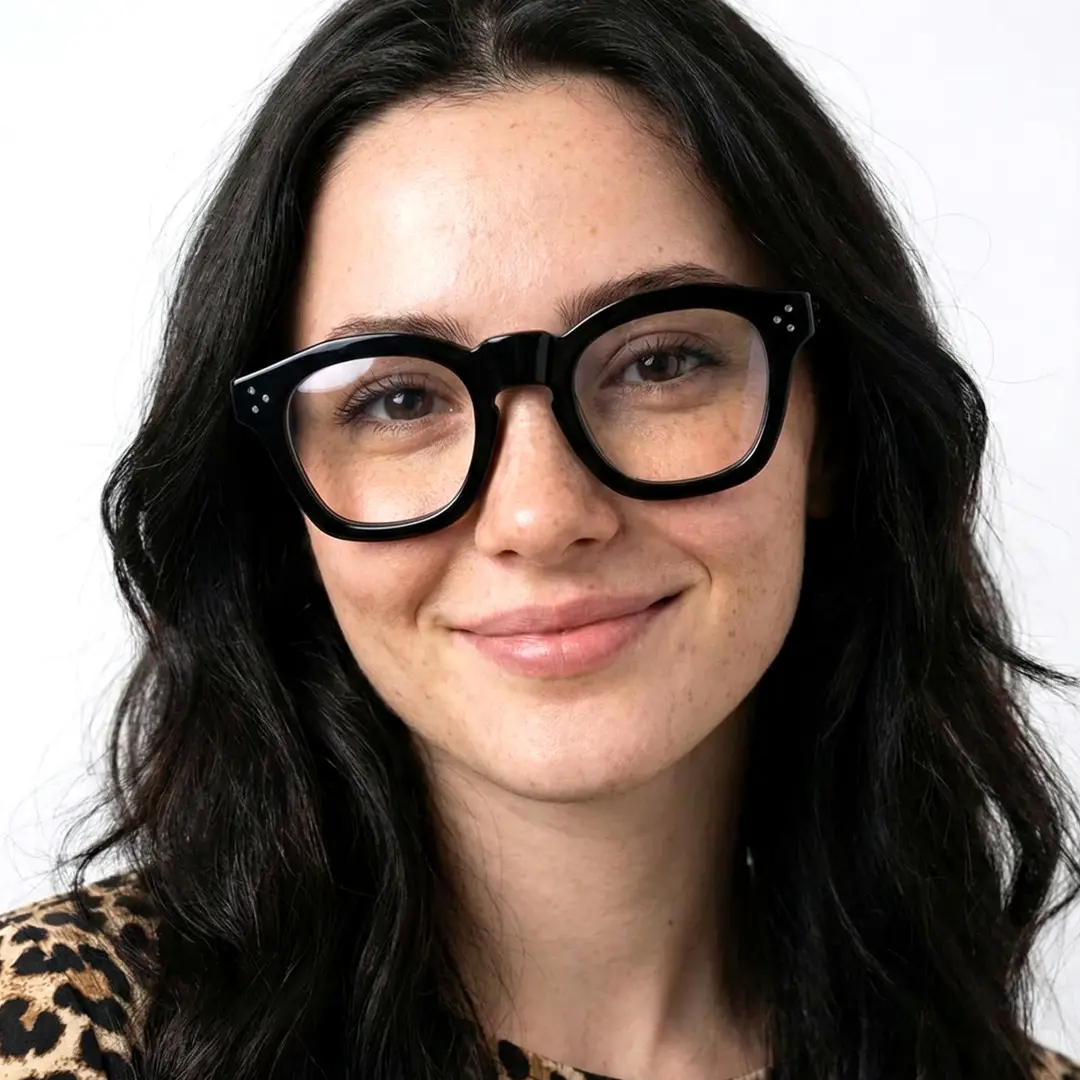 Tilted head view of female wearing vintage black cat eye eyeglasses, natural smile, CA0542302