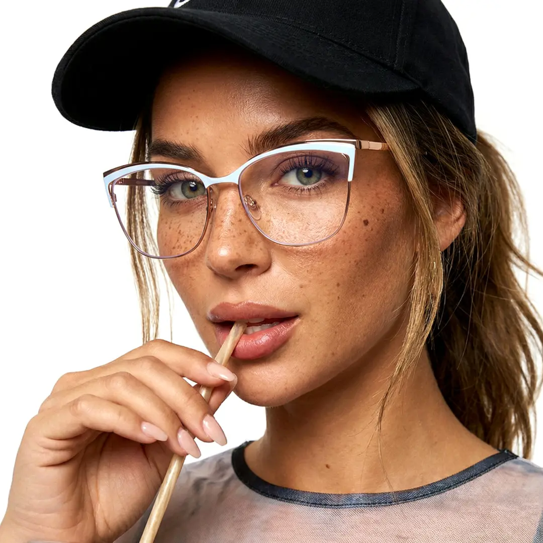 Three-quarter view of female wearing blue cat eye eyeglasses, holding a straw in mouth, neutral expression, CM0022208