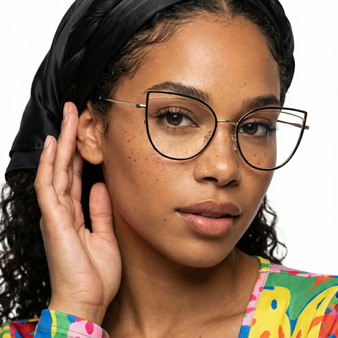 Front view of female wearing black cat eye eyeglasses, hand near face, calm expression, CM0042408