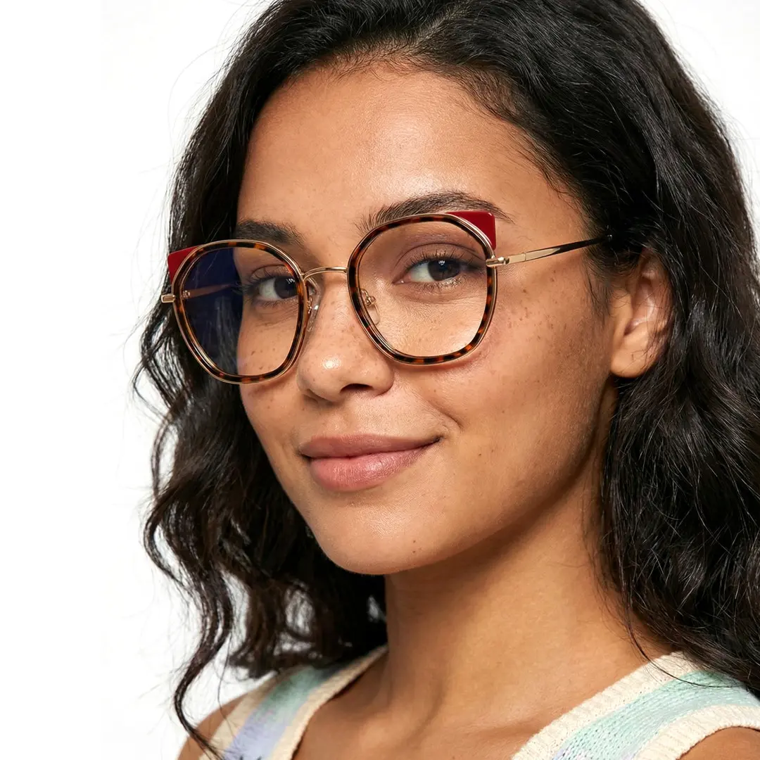 Three-quarter view of female wearing tortoise cat eye eyeglasses, natural smile, CM0162401