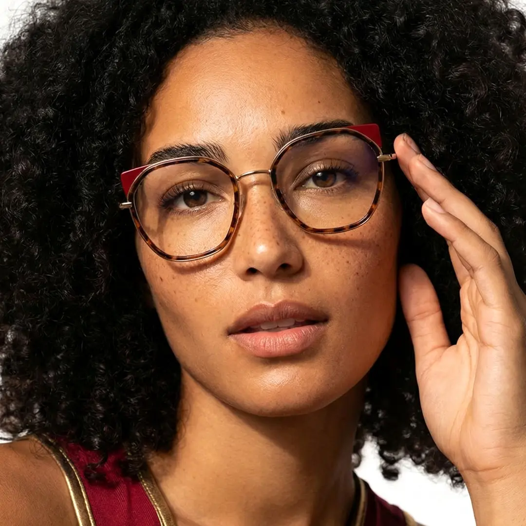 Front view of female wearing tortoise cat eye eyeglasses, neutral expression, CM0162401