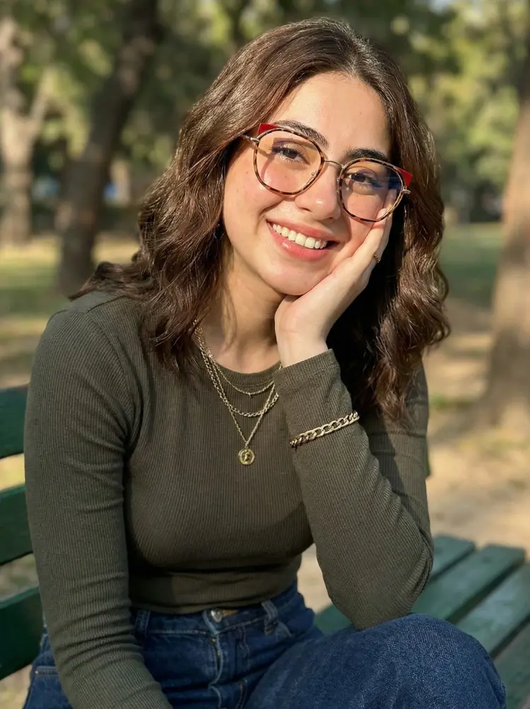 Female model wearing everyday tortoise cat eye metal eyeglasses in park. SPU: CM0162401