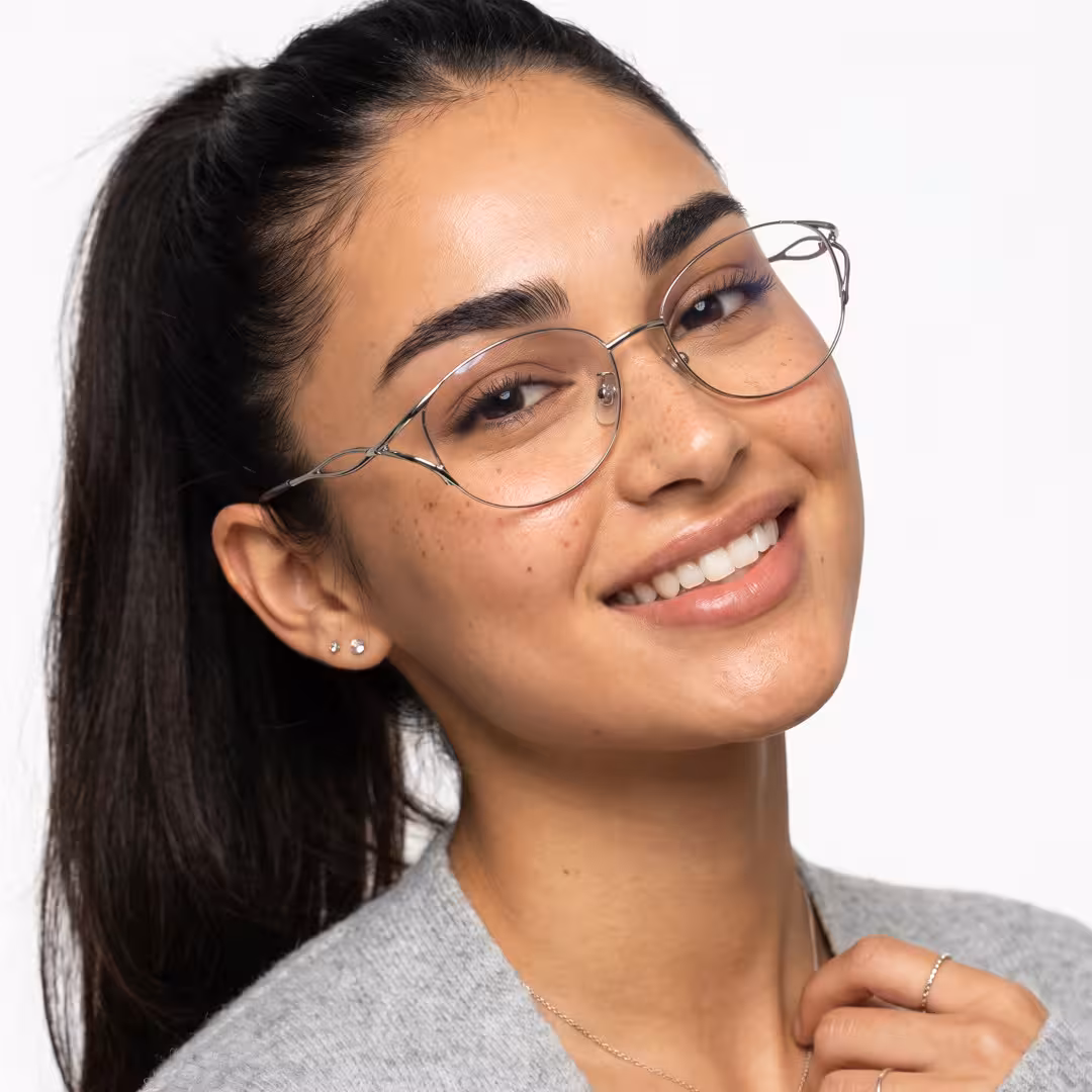 Three-quarter view of female wearing fashion silver cat eye eyeglasses, smiling, CM0282605