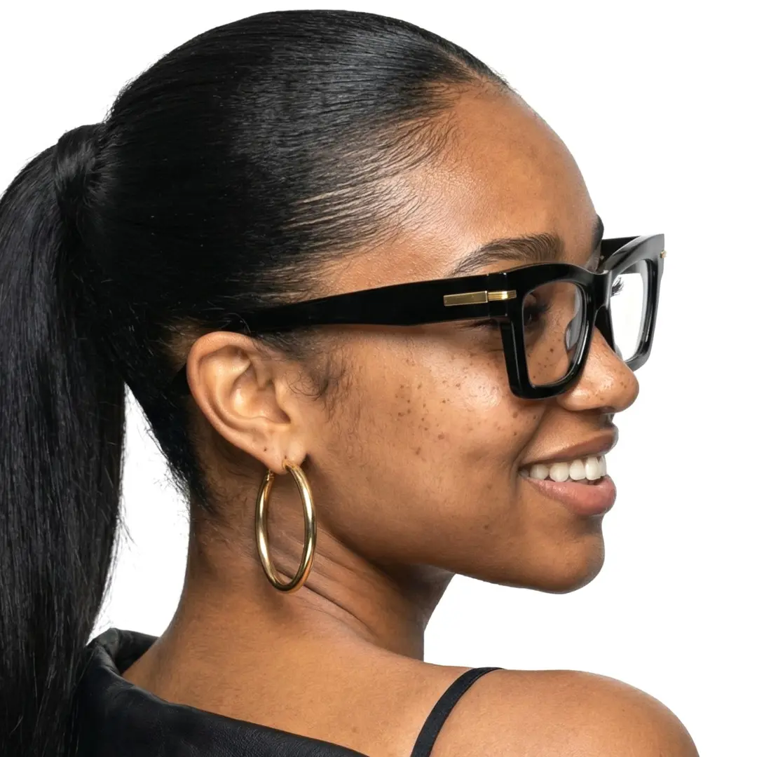Over-the-shoulder view of female wearing black cat eye eyeglasses, friendly smile, CP0012603