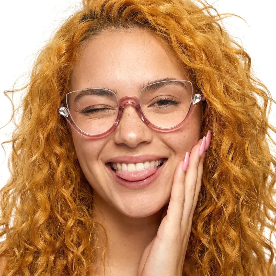 Face close-up view of female wearing colorful pink cat eye eyeglasses, hand near face, smiling, CP0032211
