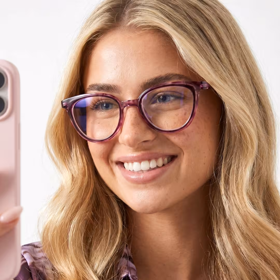 Female wearing purple cat eye pc eyeglasses, smiling while taking a selfie. SPU: CP0082605