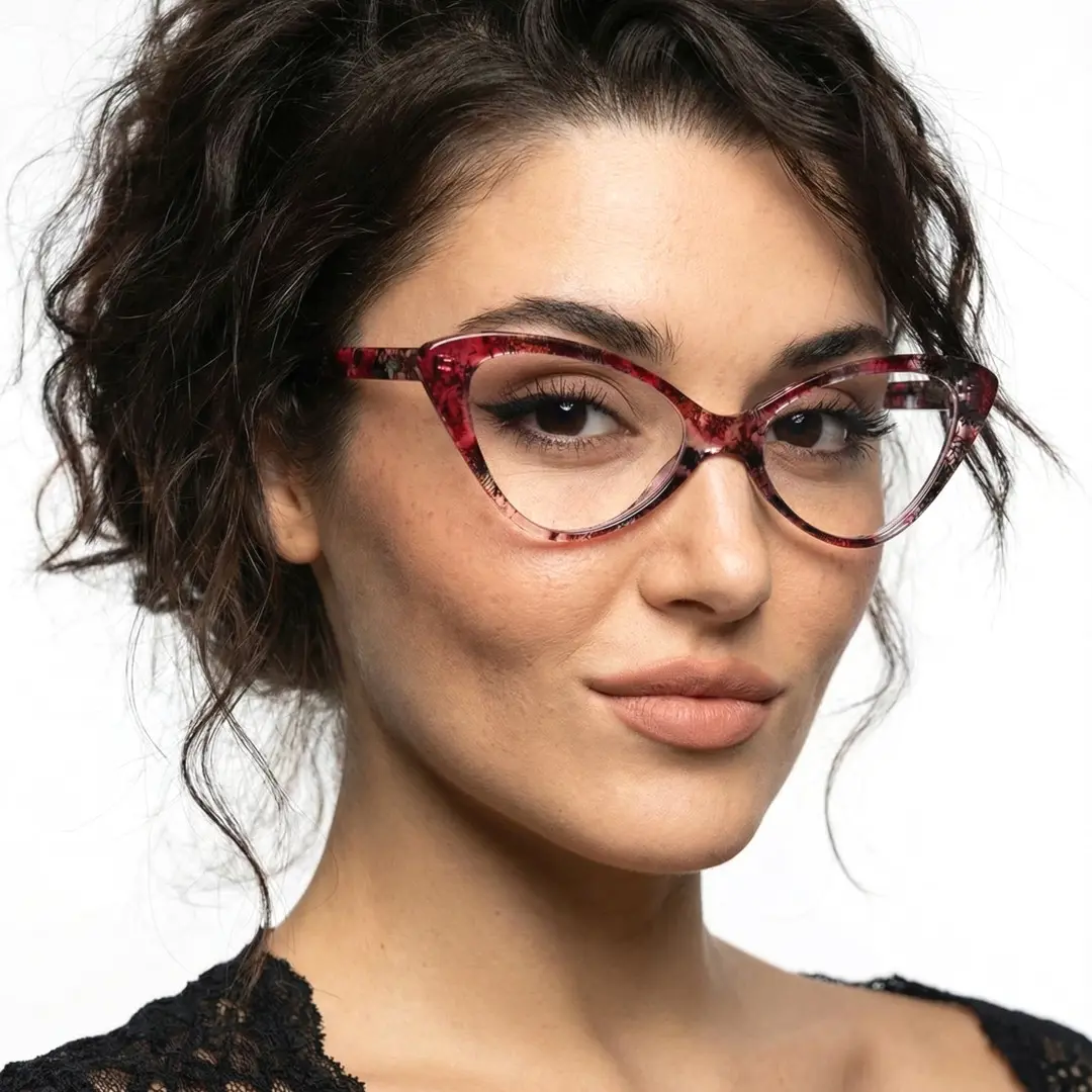 Three-quarter view of female wearing red tortoise cat eye eyeglasses, soft smile, CP0092404
