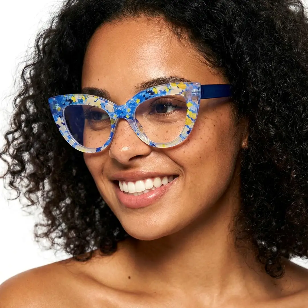 Profile view of female wearing blue cat eye eyeglasses, smiling, CP0102406