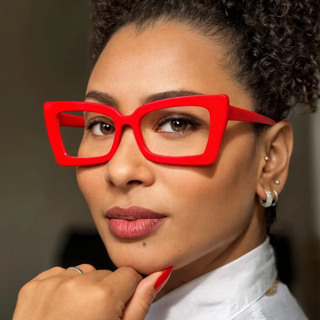 Three-quarter view of female wearing red butterfly eyeglasses, smiling, CP0162310