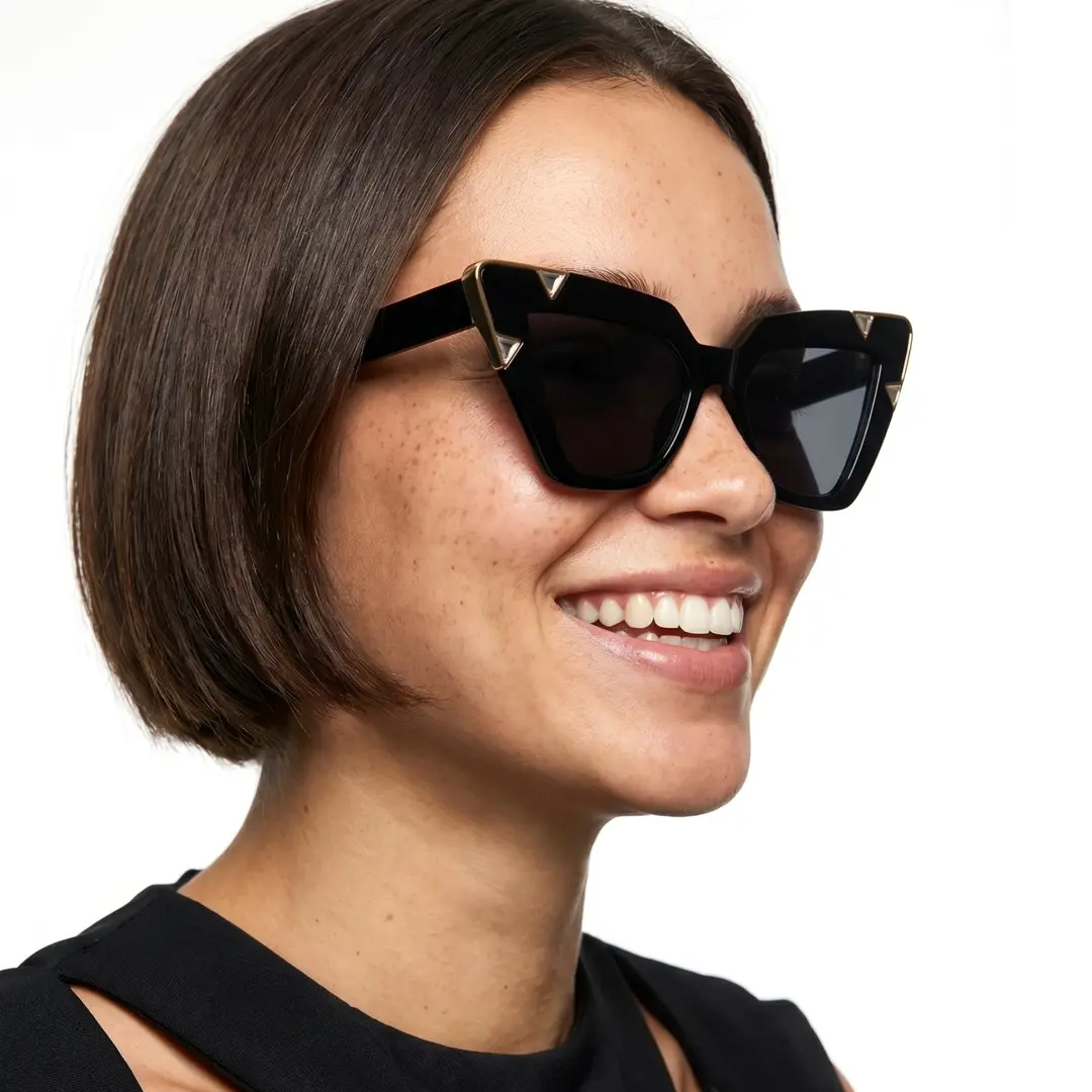Profile view of female wearing black cat eye sunglasses, smiling, CP0222604