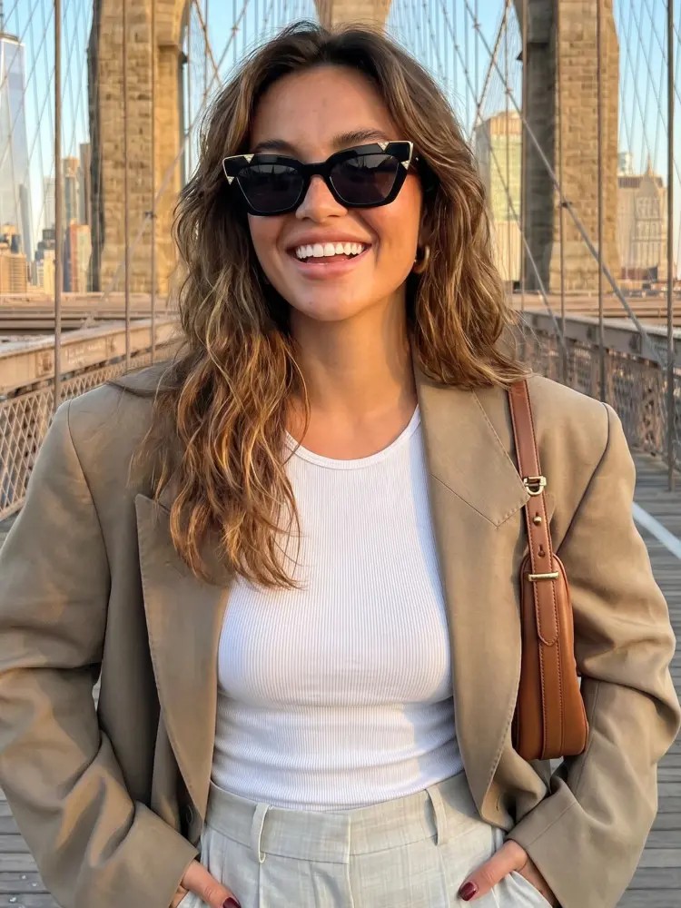 Female model wearing luxury black cat eye pc sunglasses on the Brooklyn Bridge in New York. SPU: CP0222604