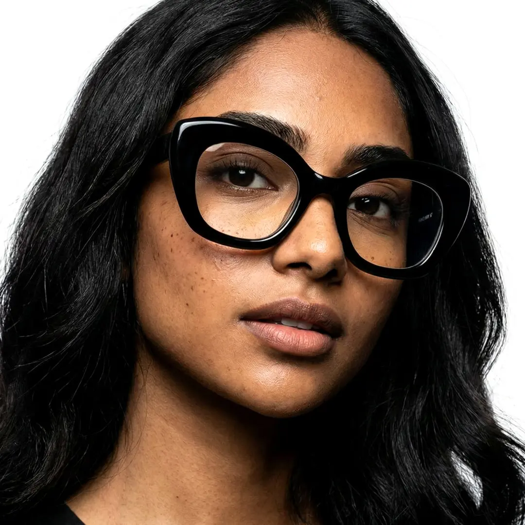 Three-quarter view of female wearing oversized black cat eye eyeglasses, neutral expression, CP0302403