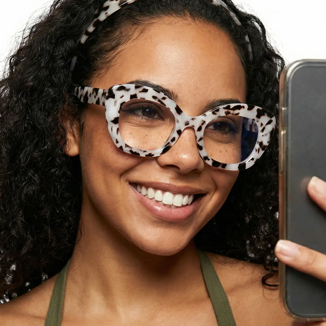 Front view of female wearing grey cat eye eyeglasses, taking a selfie, smiling, CP0302403