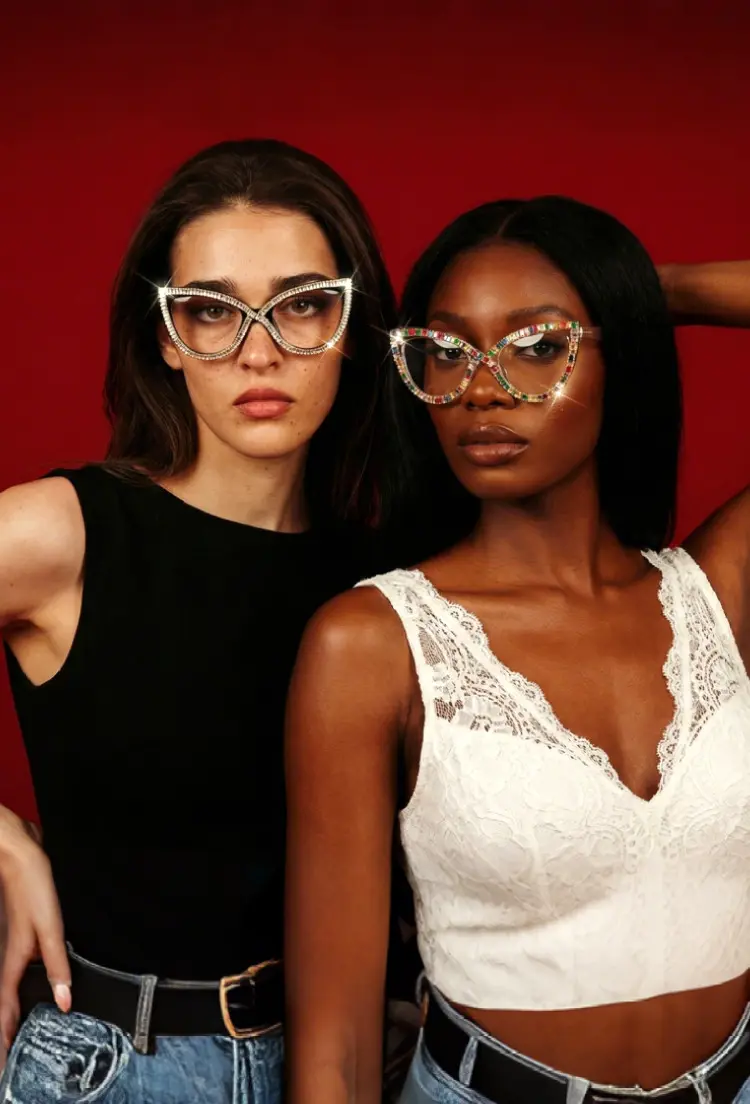 Two people models wearing elton john multicolor cat eye pc eyeglasses in red studio. SPU: CP0322412