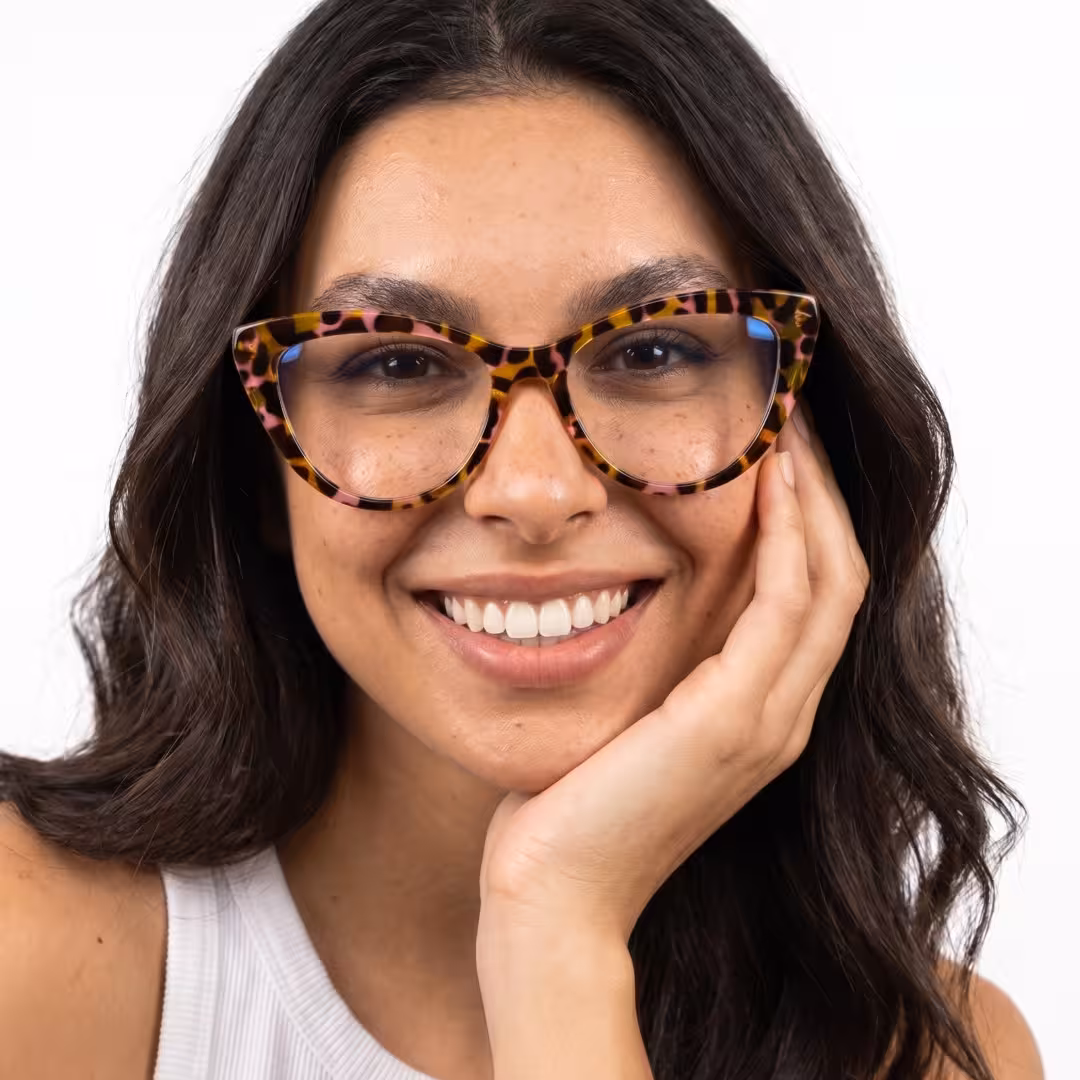 Front view of female wearing vintage tortoise cat eye eyeglasses, resting chin on hand, natural smile, CP0322604