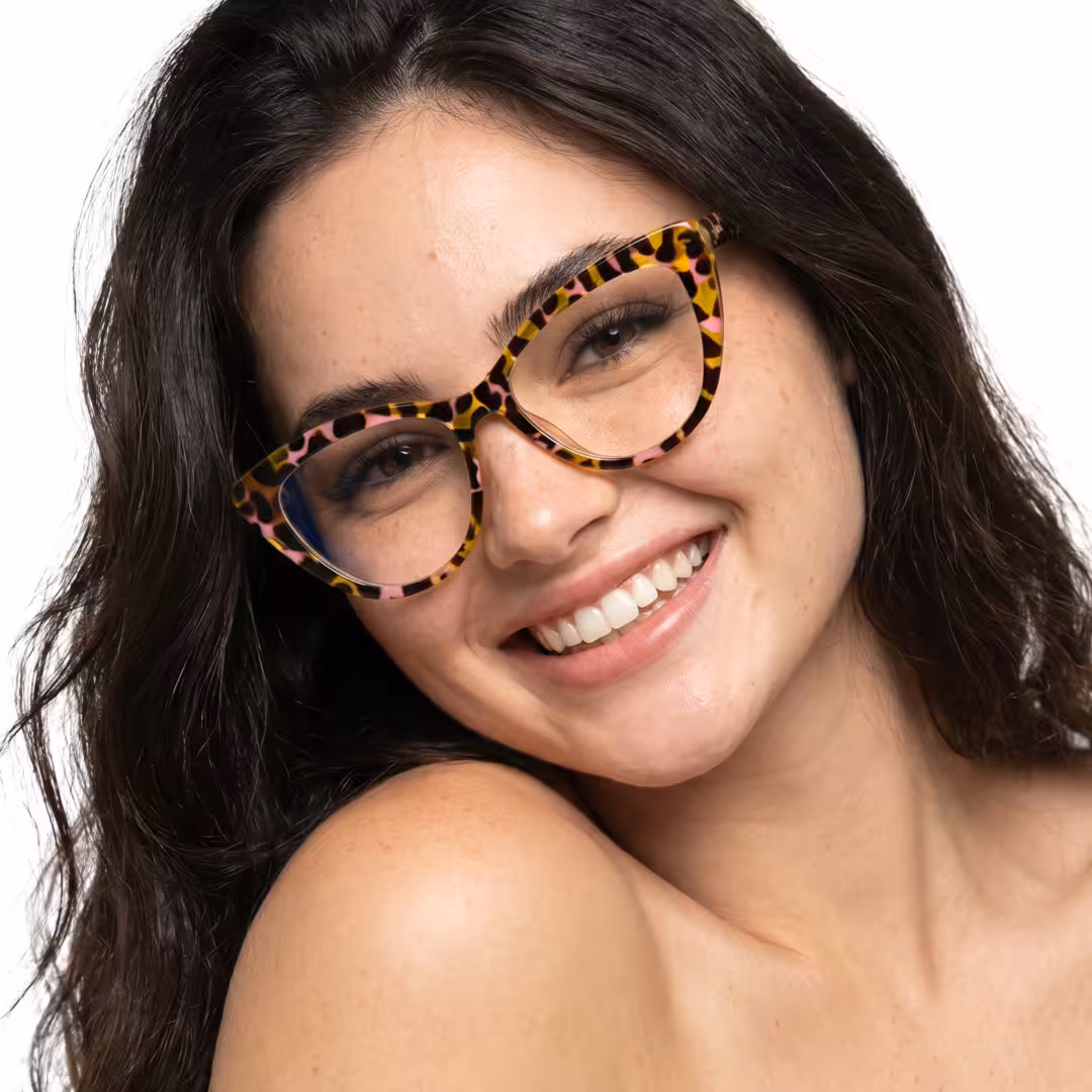 Tilted head view of female wearing vintage tortoise cat eye eyeglasses, smiling, CP0322604