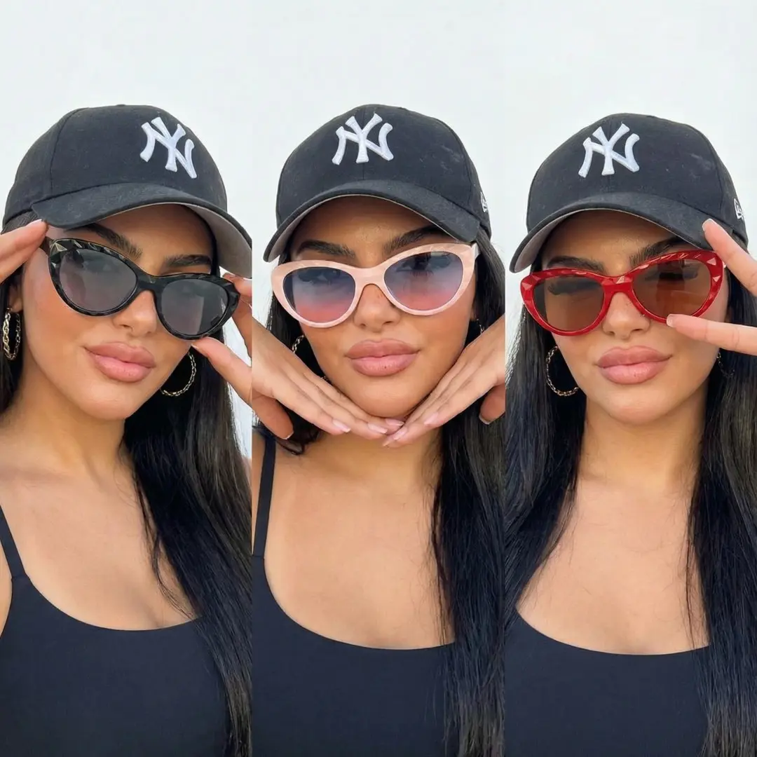 Front view of female wearing black cat eye magnetic clip-on eyeglasses set with interchangeable clip-on lenses, hand near face, calm expression, CP0422506
