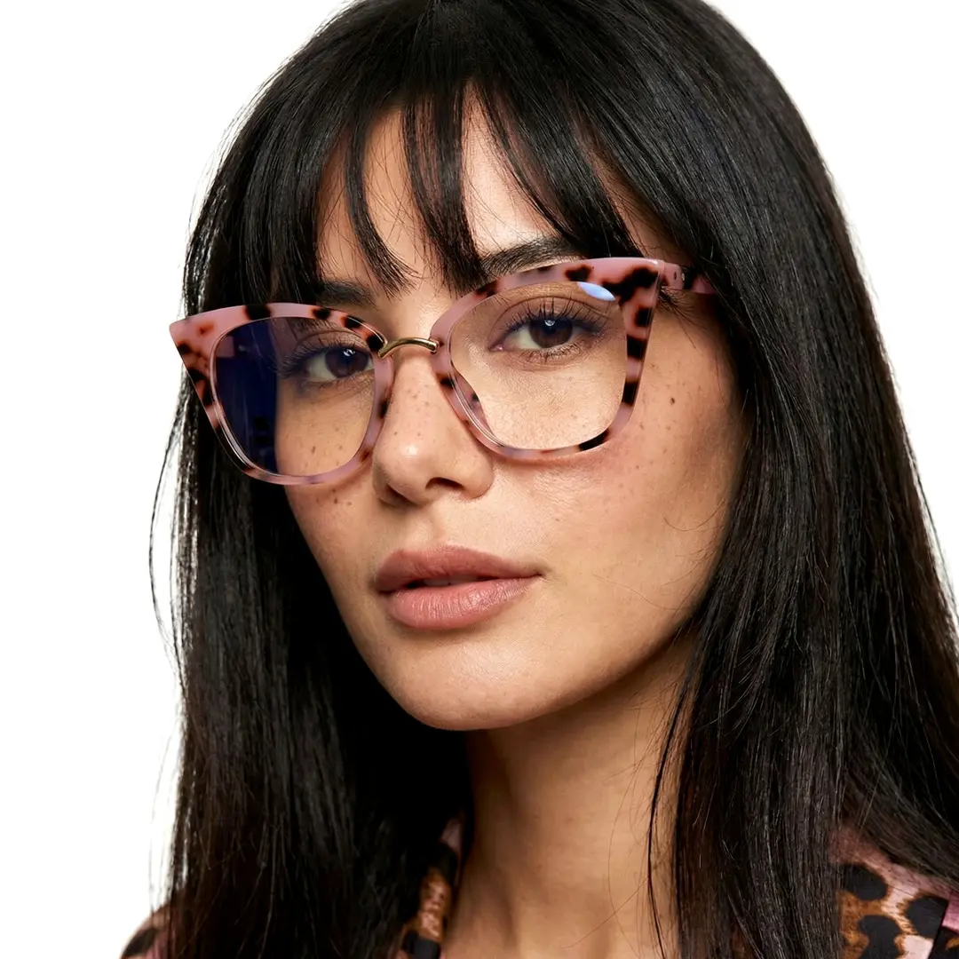 Close-up view of female wearing red tortoise cat eye eyeglasses, relaxed expression, CR0012211