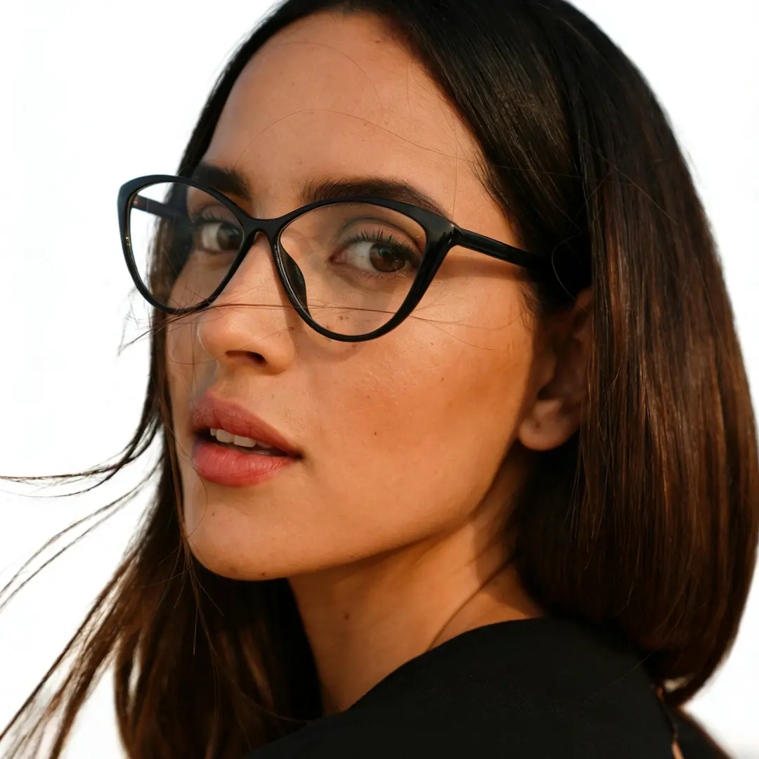 Over-the-shoulder view of female wearing black cat eye eyeglasses, neutral expression, CR0012507
