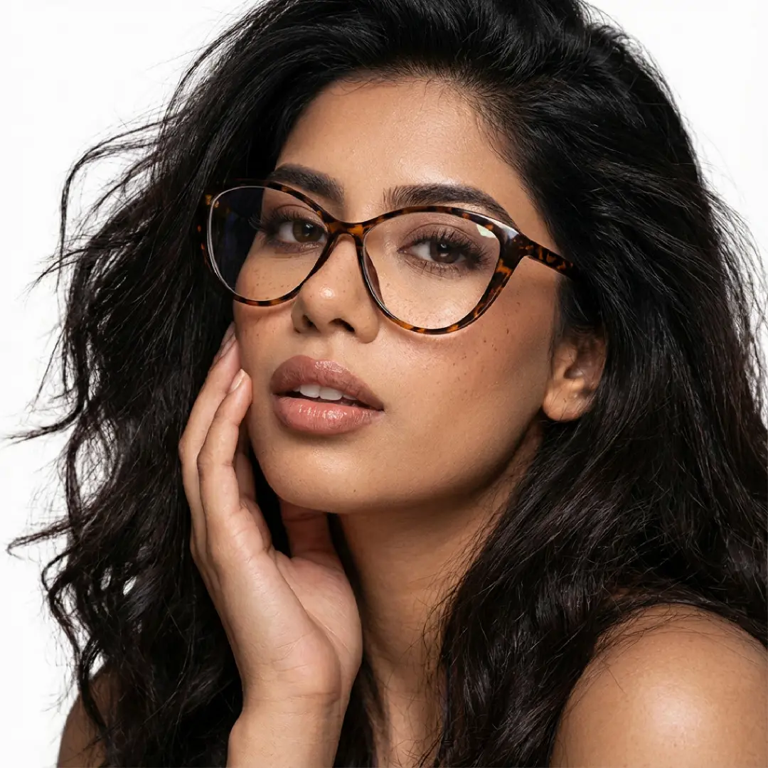 Looking straight ahead view of female wearing tortoise cat eye eyeglasses, hand touching lips, neutral expression, CR0012507