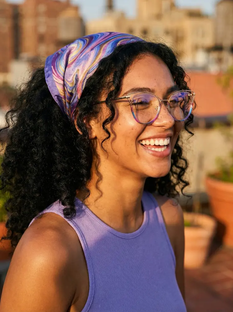 Female model wearing colorful multicolor cat eye tr90 eyeglasses on a city rooftop terrace. SPU: CR0032501