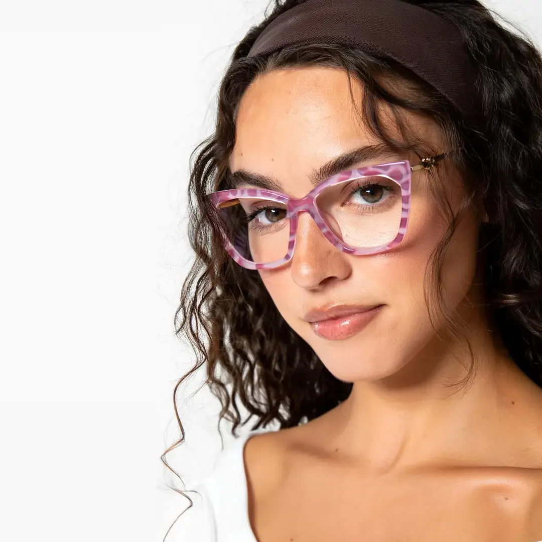 Front view of female wearing pink cat eye eyeglasses, natural smile, CR0042310
