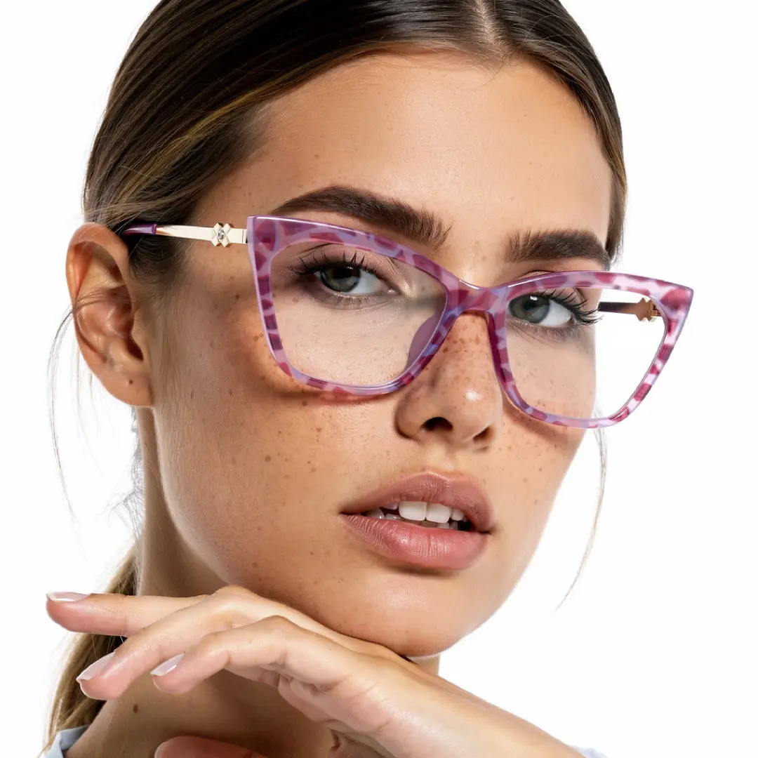 Front view of female wearing pink cat eye eyeglasses, resting chin on hand, natural expression, CR0042310
