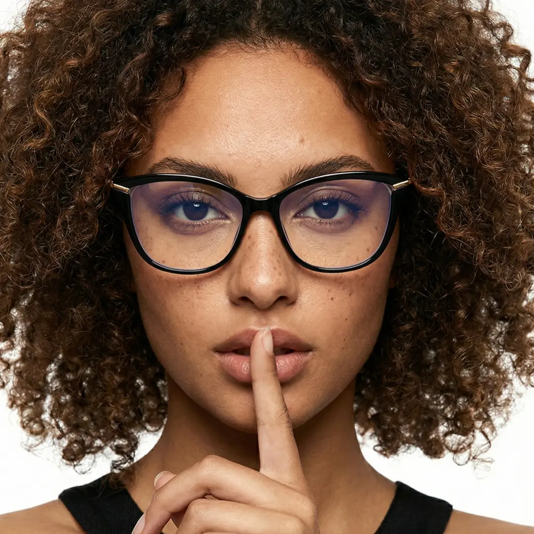 Front view of female wearing black cat eye eyeglasses, calm expression, CR0042404