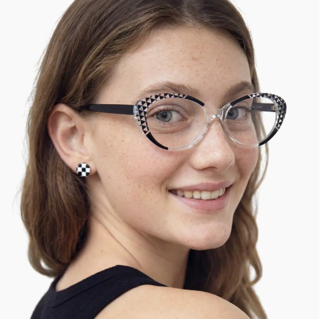 Three-quarter view of female wearing black cat eye eyeglasses, smiling, CR0042405