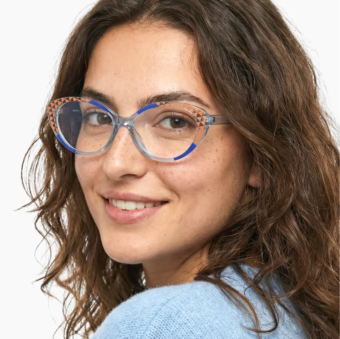 Over-the-shoulder view of female wearing blue cat eye eyeglasses, smiling, CR0042405