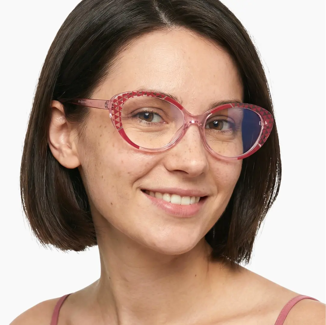 Three-quarter view of female wearing red tortoise cat eye eyeglasses, smiling, CR0042405