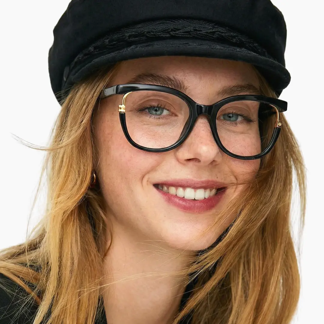 Slightly angled view of female wearing black cat eye eyeglasses, smiling, CR0042501