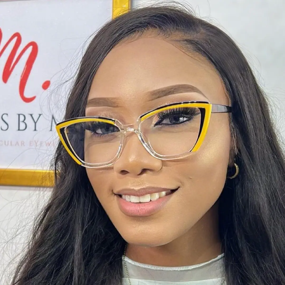 Front view of female wearing colorful yellow cat eye eyeglasses, smiling, CR0052307