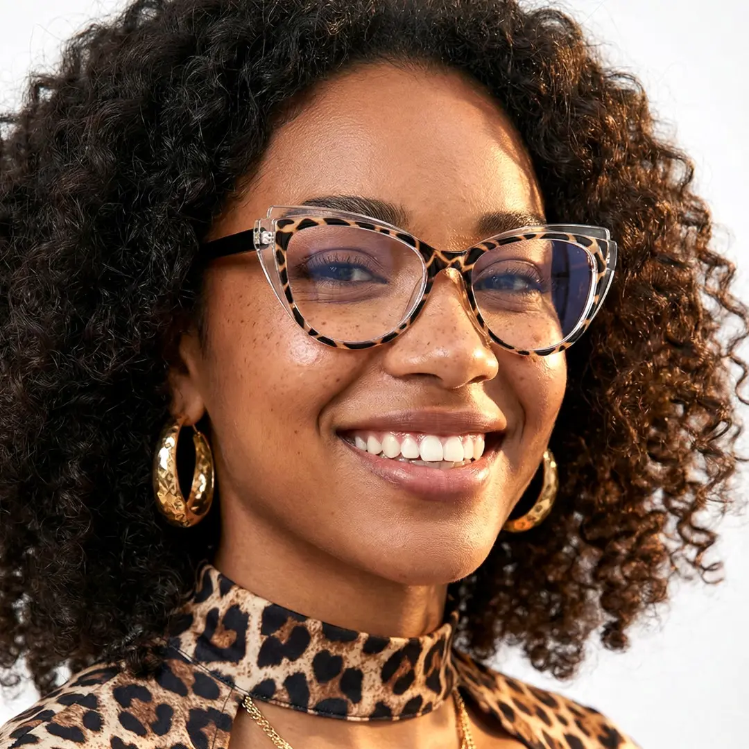 Three-quarter view of female wearing tortoise cat eye eyeglasses, smiling, CR0052403