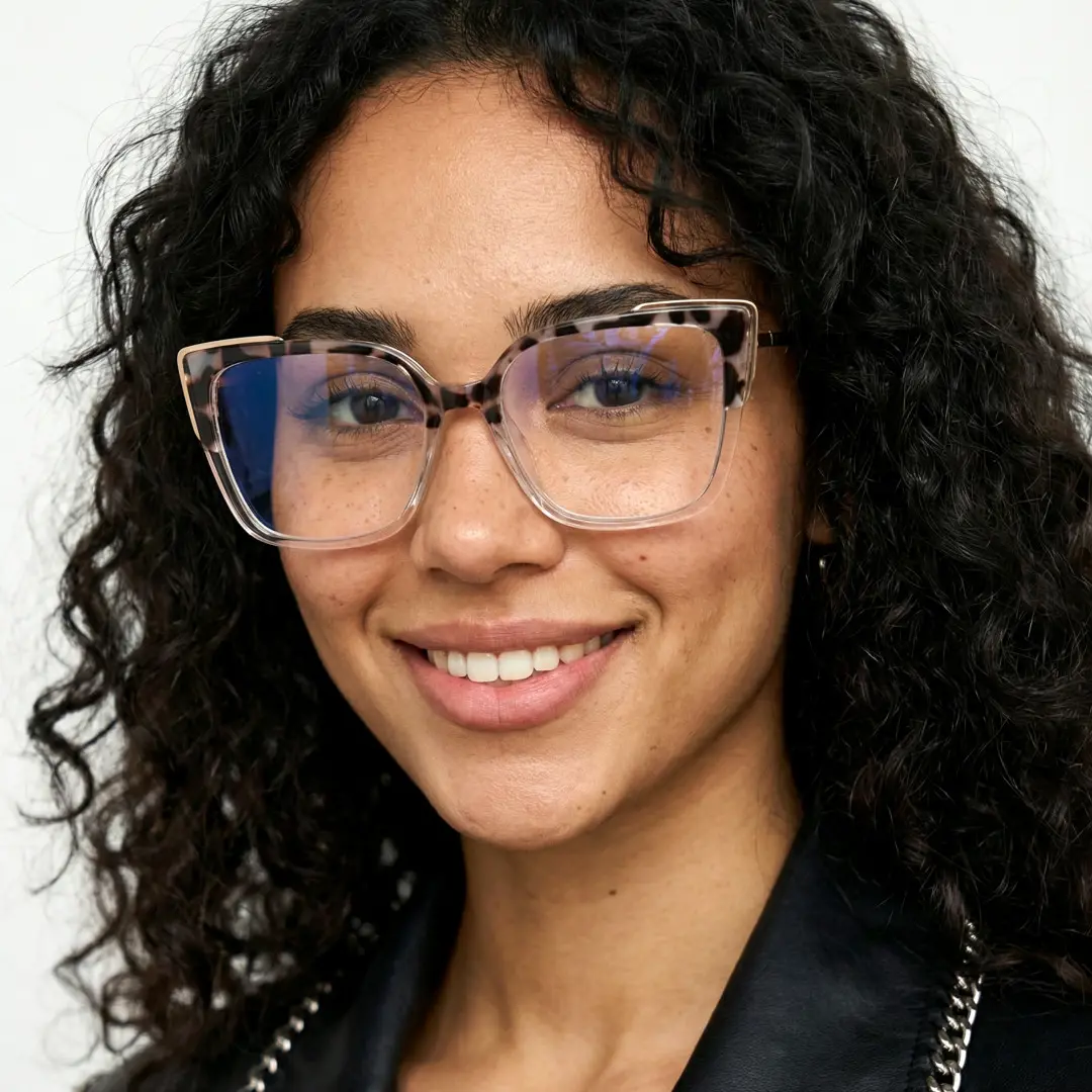 Slightly angled view of female wearing brown tortoise cat eye eyeglasses, natural smile, CR0052409