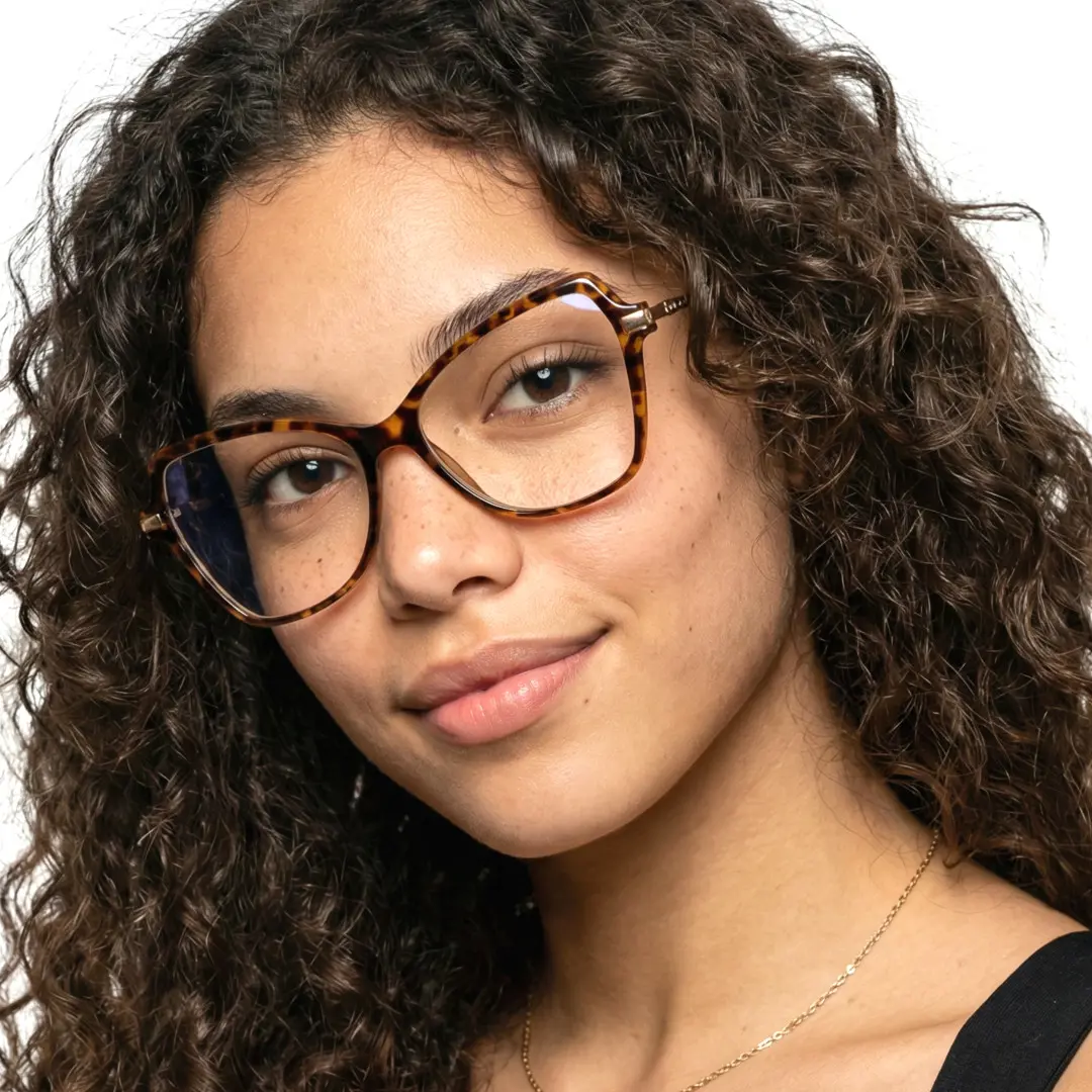 Tilted head view of female wearing tortoise cat eye eyeglasses, neutral expression, CR0052411