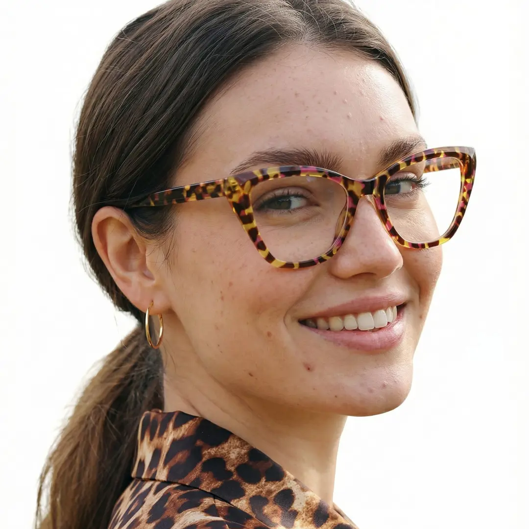 Over-the-shoulder view of female wearing yellow tortoise cat eye eyeglasses, smiling, CR0062411
