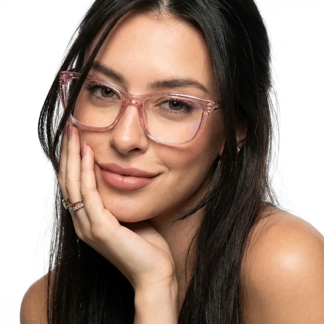 Front view of female wearing pink cat eye eyeglasses, resting chin on hand, friendly smile, CR0062510