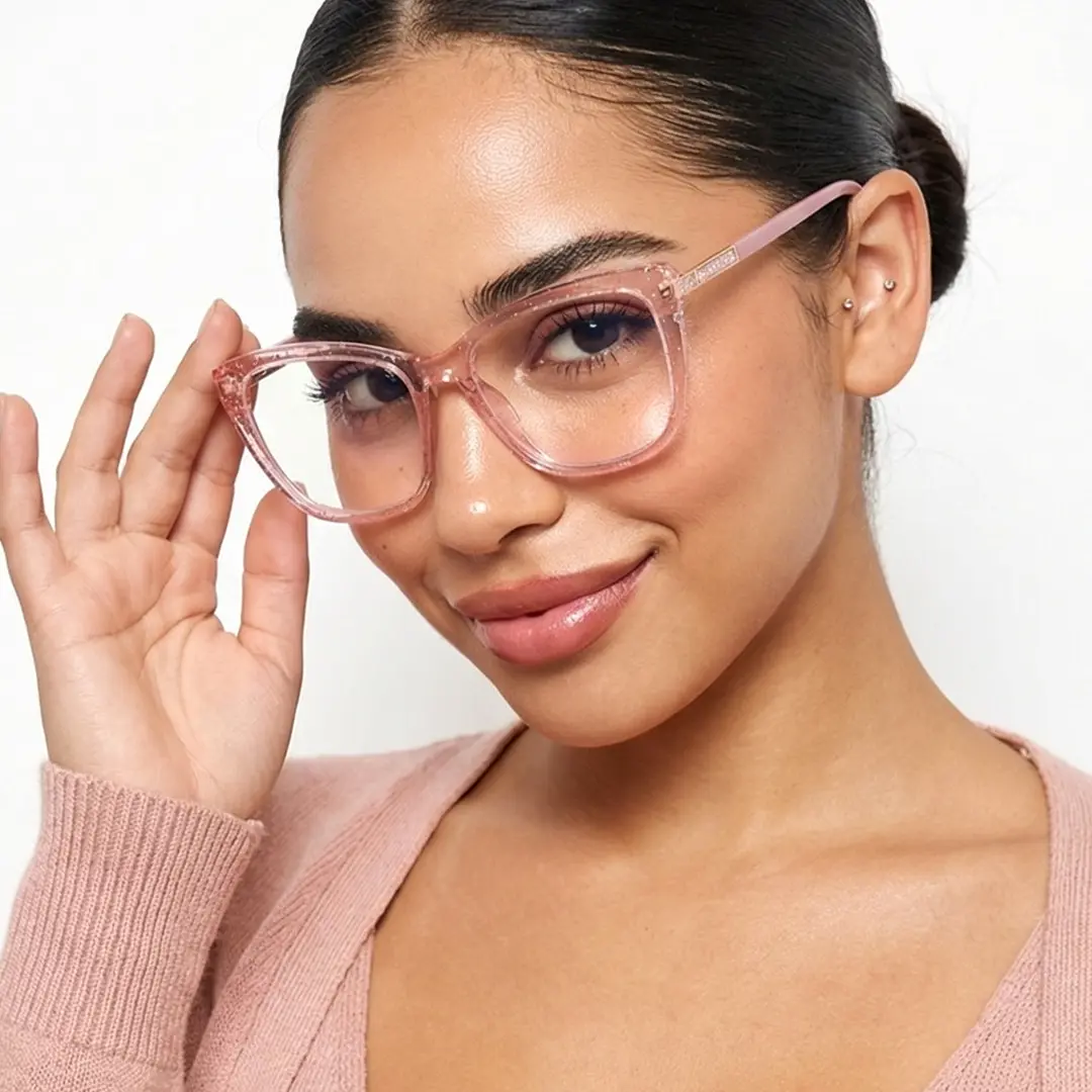 Three-quarter view of female wearing pink cat eye eyeglasses, touching frame, smiling, CR0062510