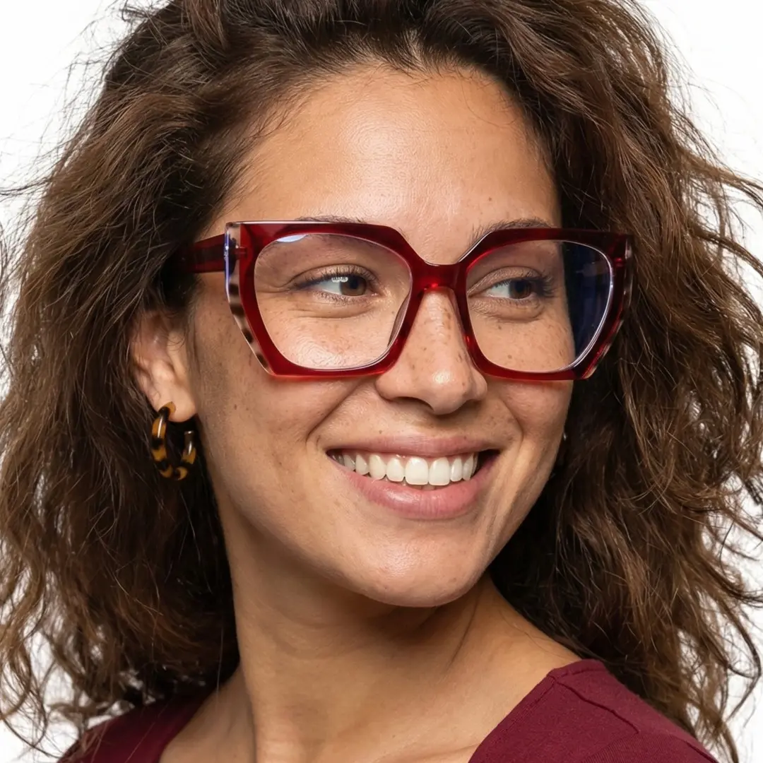 Slightly angled view of female wearing fashion red cat eye eyeglasses, natural smile, CR0072403