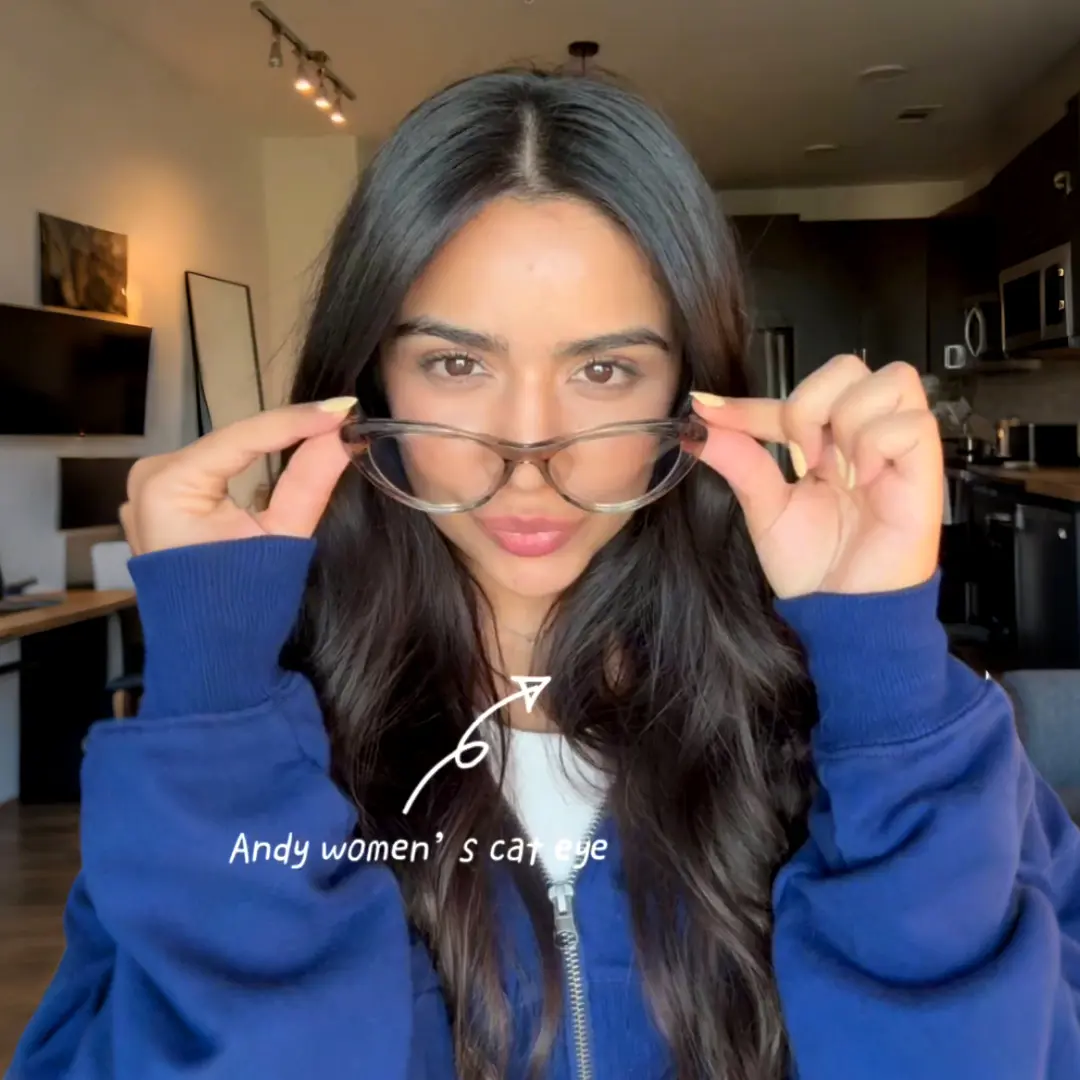 Front view of female wearing maize yellow cat eye eyeglasses, holding glasses, neutral expression, CR0072404