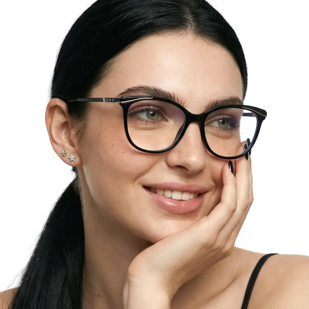 Looking away view of female wearing black cat eye eyeglasses, resting chin on hand, natural smile, CR0072408