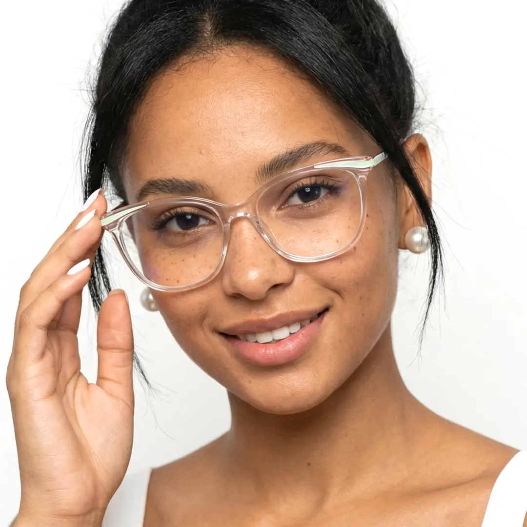 Front view of female wearing clear cat eye eyeglasses, holding glasses, friendly smile, CR0072408