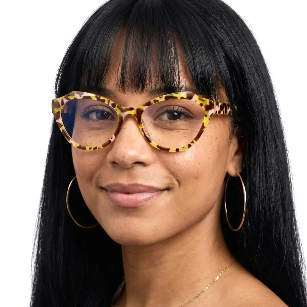 Front view of female wearing yellow tortoise cat eye eyeglasses, soft smile, CR0082411