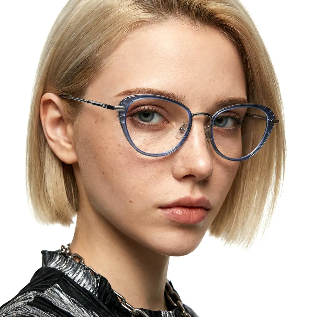 Close-up view of female wearing blue cat eye eyeglasses, relaxed expression, CR0102402