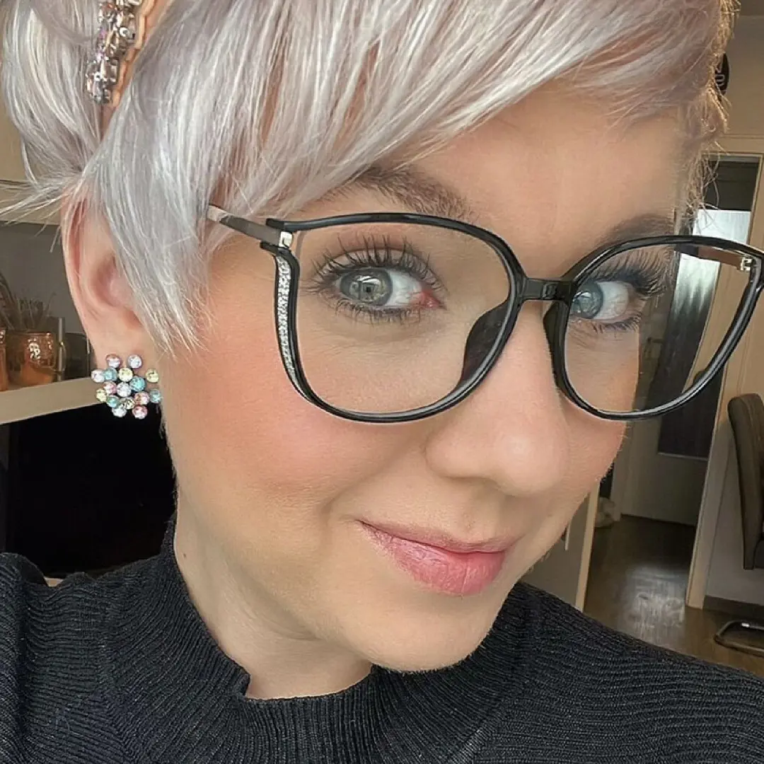 Close-up view of female wearing black cat eye eyeglasses, neutral expression, CR0102409