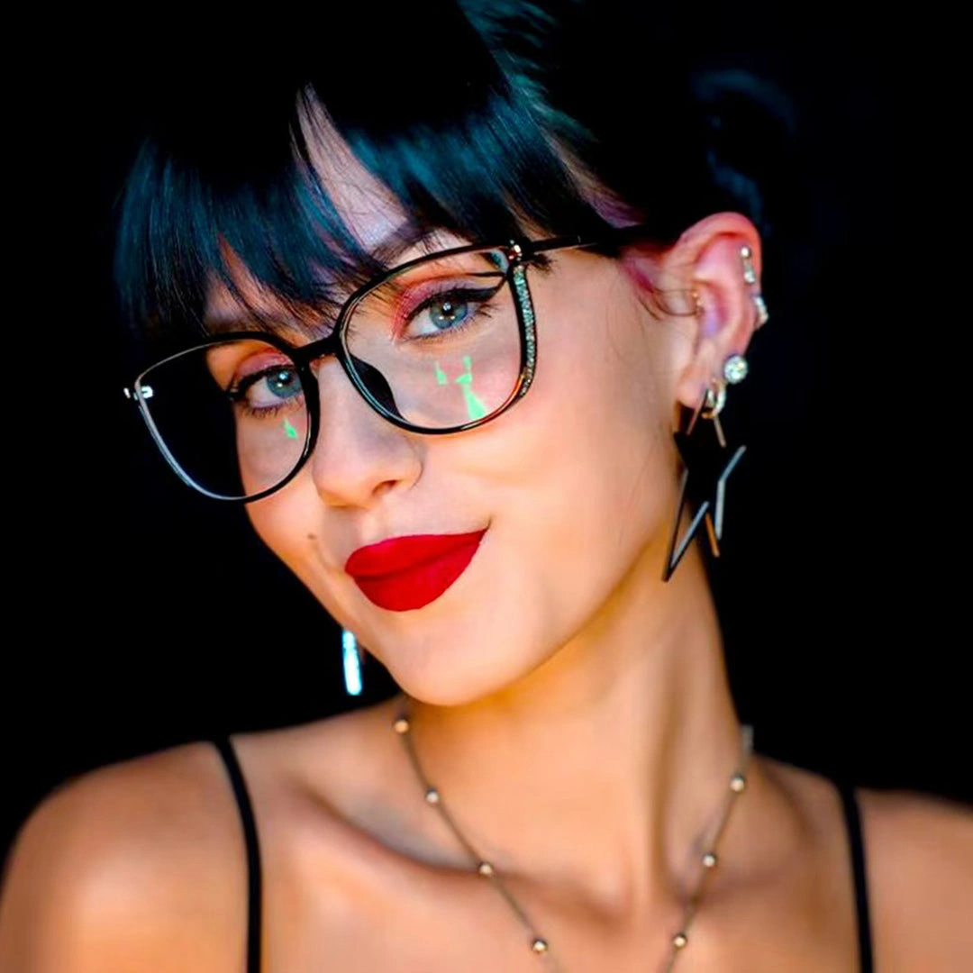 Tilted head view of female wearing black cat eye eyeglasses, natural smile, CR0102409