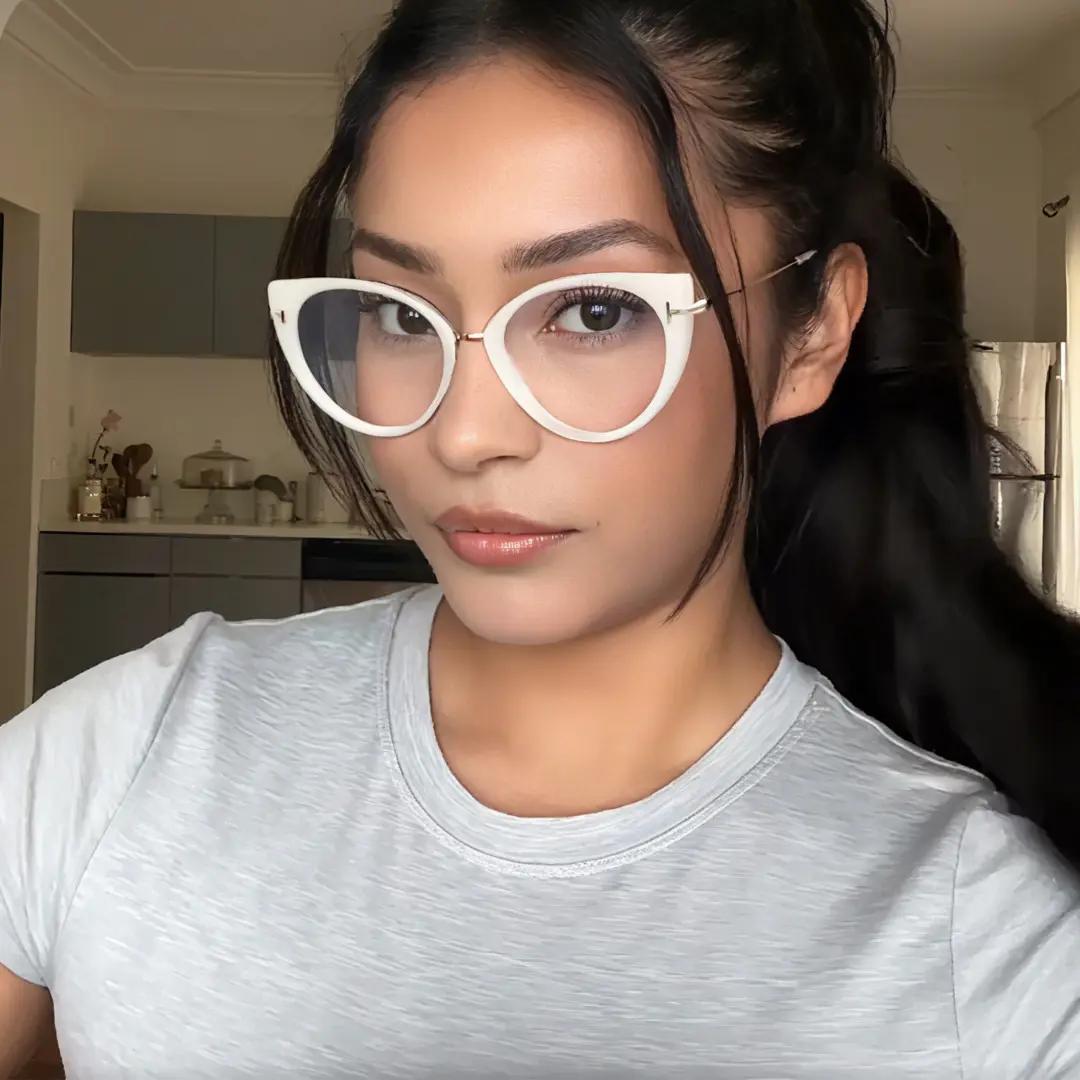Slightly angled view of female wearing fashion white cat eye eyeglasses, neutral expression, CR0112402
