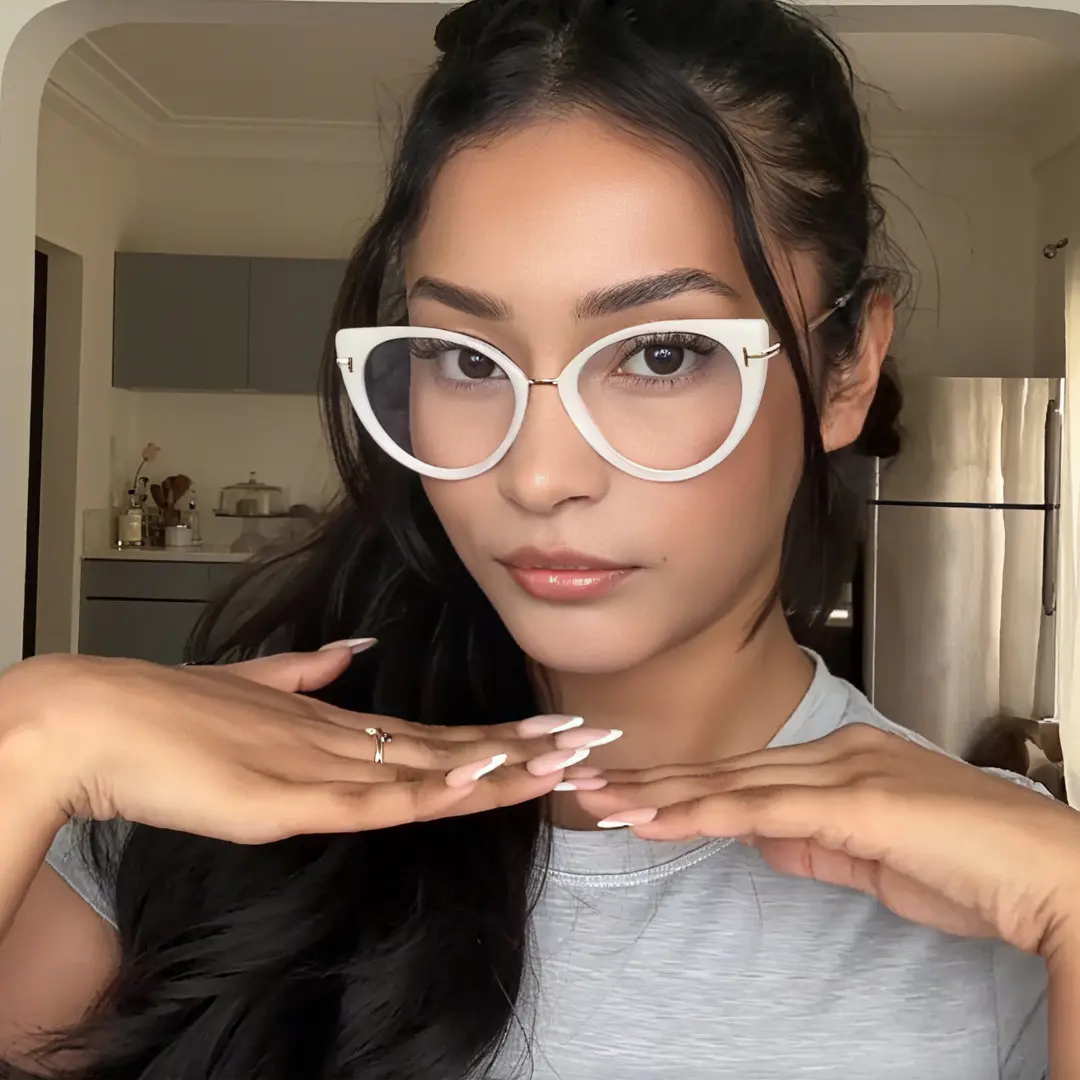 Front view of female wearing white cat eye eyeglasses, natural expression, CR0112402